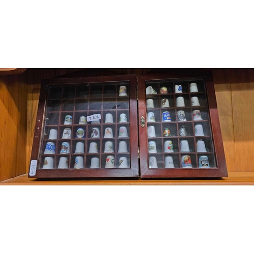 262 - QTY OF VINTAGE SOUVENIR SPOONS ON STANDS, QTY OF BONE CHINA THIMBLES & AN OAK FRAMED OCTAGONAL MIRRO... 