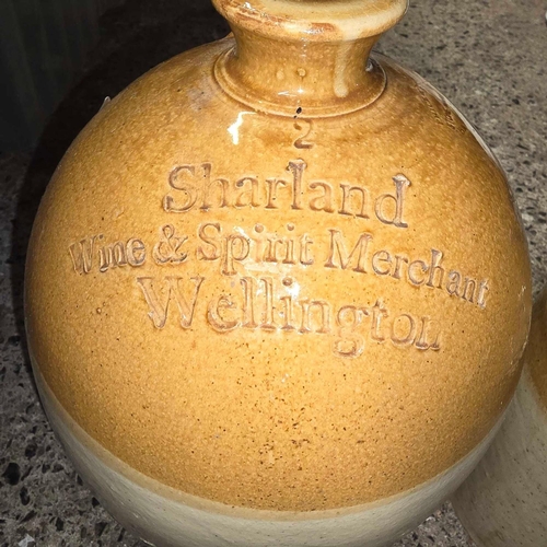 153 - 2 GLAZED STONEWARE FLAGON'S 1 MARKED SHARLAND WINE & SPIRIT MERCHANTS, WELLINGTON & 1 MARKED P & AH ... 