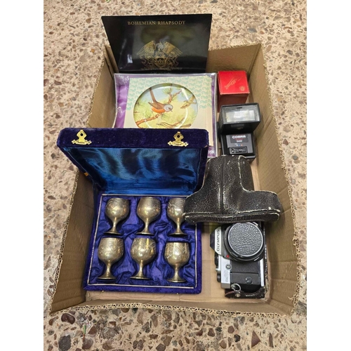 25 - 3 CARTONS OF MISC BRIC-A-BRAC INCL; SNOW GLOBES, SMALL GOBLET SET, BRASS BELL, OLYMPUS OM20 CAMERA E... 