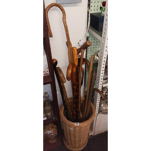 424 - WICKER STICK BASKET & LARGE QTY OF WALKING STICKS