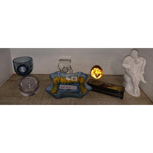 375 - SHELF OF VARIOUS GLASS ORNAMENTS, PAPERWEIGHTS, BLUE GOBLET, CLOCK & FIGURE WITH CHILD ON THEIR LAP