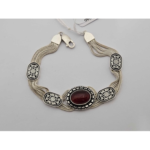 865 - FANCY SILVER 4 STRAND BRACELET WITH CENTRAL RED STONE