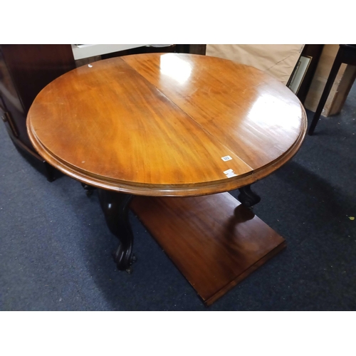 323 - MAHOGANY CIRCULAR EXTENDING DINING TABLE ON CASTERS