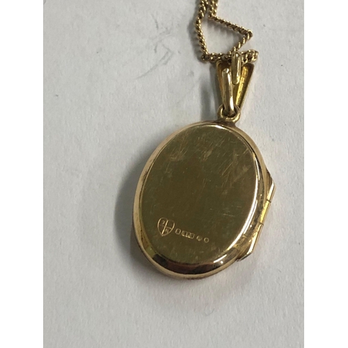 747 - AN OVAL 9ct GOLD HINGED LOCKET ON 9ct NECK CHAIN. 3.4g