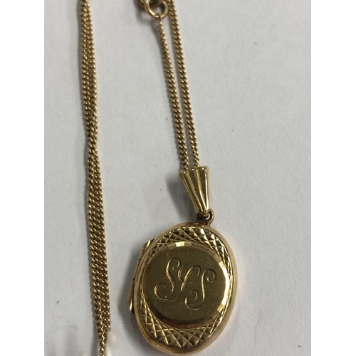 834 - AN OVAL 9ct GOLD HINGED LOCKET ON 9ct NECK CHAIN. 3.4g