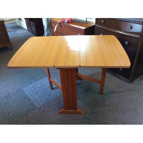 524 - A Formica topped dropleaf space saver dining table.