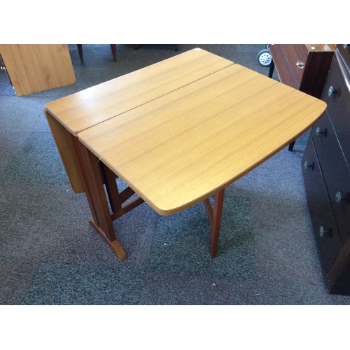 524 - A Formica topped dropleaf space saver dining table.