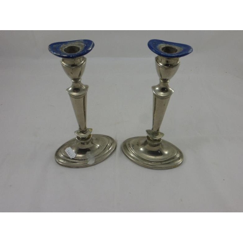 250 - A pair of silver plated candlesticks