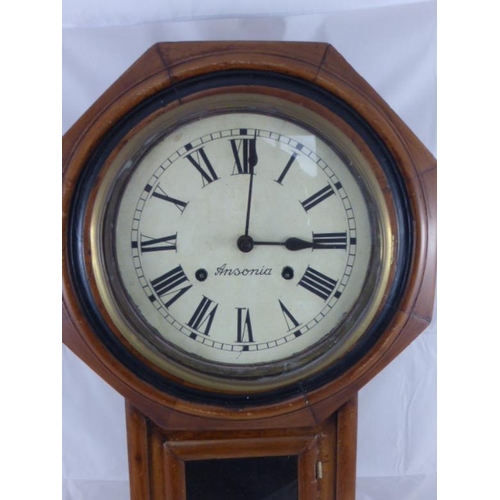 286 - Oak Cased Wall clock complete with pendulum and key