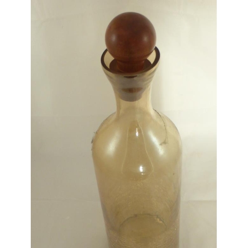 645 - A Large iridescent glass crackle bottle with wooden stopper. Savings bottle etc. approx 40cm high