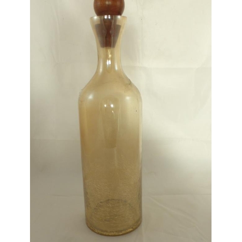 645 - A Large iridescent glass crackle bottle with wooden stopper. Savings bottle etc. approx 40cm high