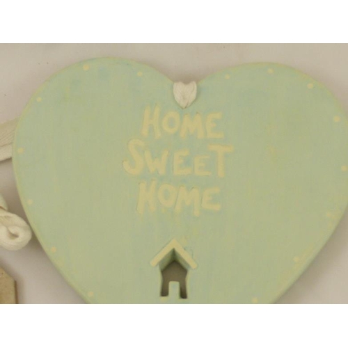 646 - A Wooden Home sweet home heart plaque and a framed row of houses with the inscription 