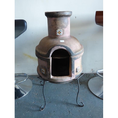 306 - A chimenea with iron stand and decorative ceramic tiles