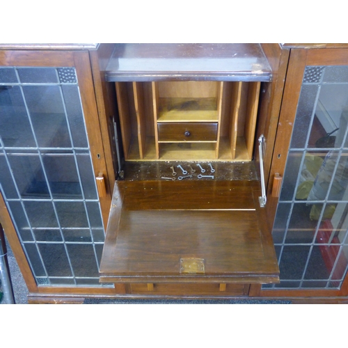 506 - Dark wood leaded glass two door central bureau over three draws