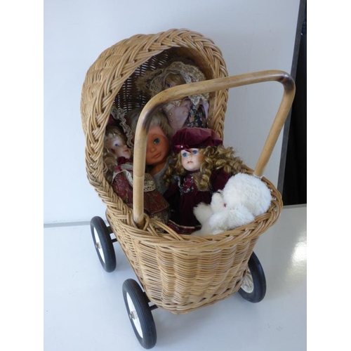 316 - Vintage Wicker perambulator with four porcelain dolls one childs dolls and soft toy dog