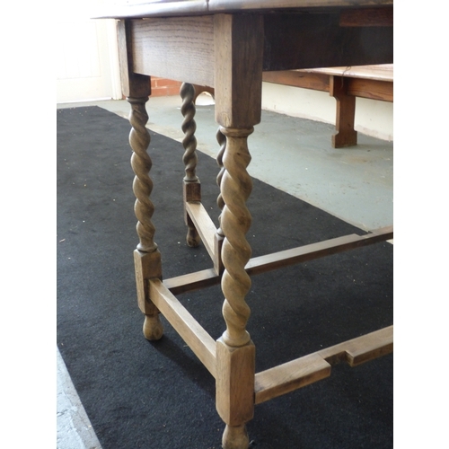 510 - Oval oak table with barley twist legs measuring 150cm x 106cm