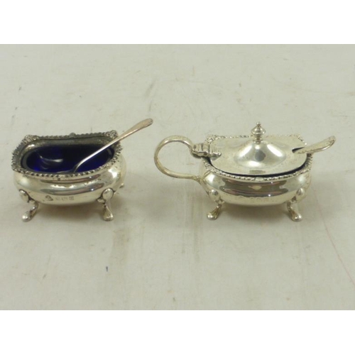 39 - Two Birmingham Hallmarked Silver Glass Lined Condiment Pots complete with Spoons (A/F) (85 grams)