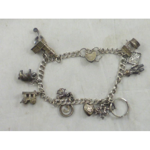 51 - Vintage silver charm bracelet with thirteen assorted charms some marked silver or sterling silver. T... 