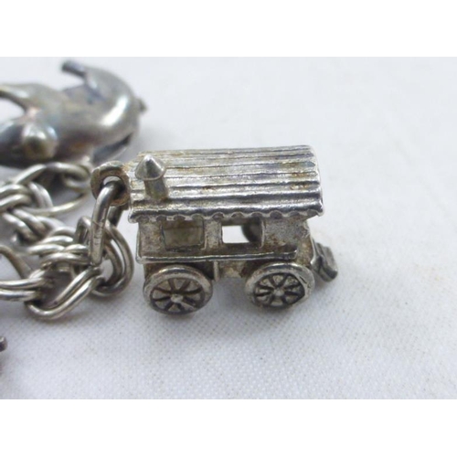 51 - Vintage silver charm bracelet with thirteen assorted charms some marked silver or sterling silver. T... 