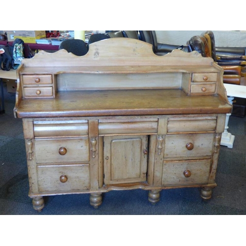 102 - Antique pine kitchen dresser complete with cupboard and eleven drawers