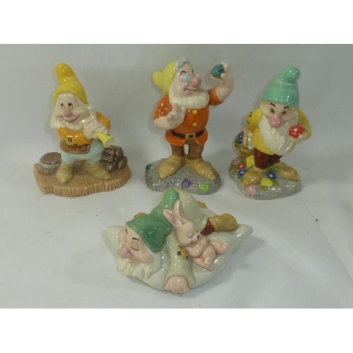 82 - Four Royal Doulton Snow White Figures Including, Dear Old Doc, Sleepy, Happy That's Me and Aw Shucks