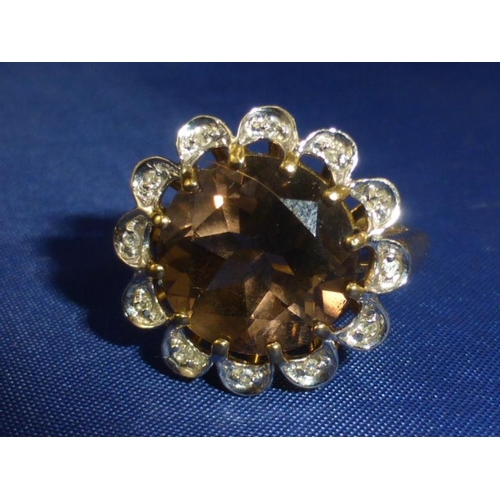 103 - Hallmarked Birmingham 375 Gold Ring with Large Brown Topaz surrounded by a mount of Diamonds (Size M... 