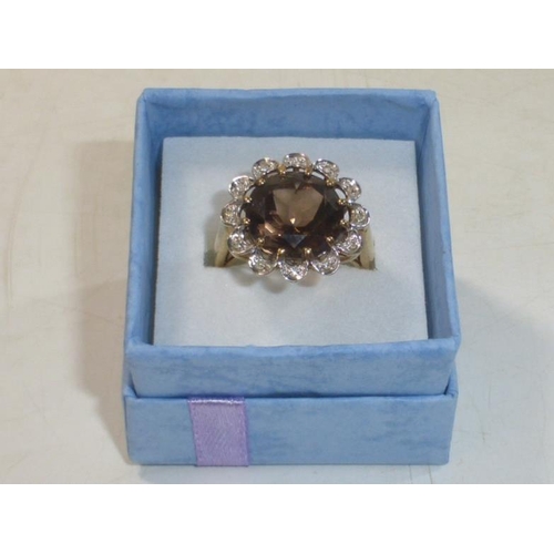 103 - Hallmarked Birmingham 375 Gold Ring with Large Brown Topaz surrounded by a mount of Diamonds (Size M... 