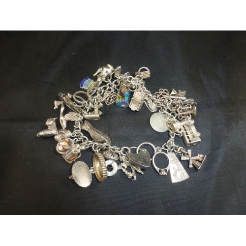 110 - Hallmarked Sterling Silver Charm Bracelet (34 Charms)