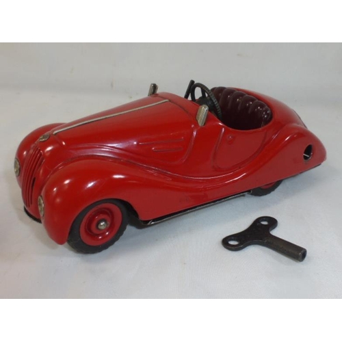 158 - Schuco Akustico 2002 car, red tinplate body, Burgundy interior with lithographed detailed dashboard,... 