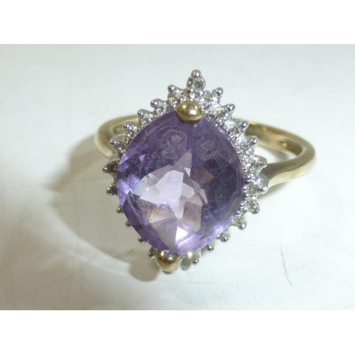 172 - Hallmarked Birmingham 375 Gold Ring with Large Amethyst center Stone Surrounded by Diamond (Size T)