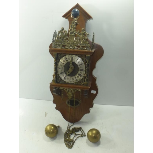 97 - Dutch style wall hanging clock, with Atlas figure and burnished metal mounts, striking the hours and... 