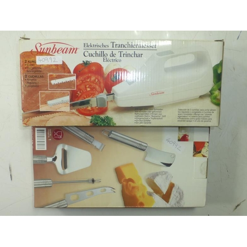 101 - A Boxed New Sunbeam Electric Carving Knife and a New boxed set of Cheese Knives.
