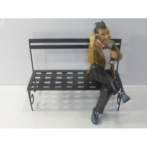 234 - Figure of Stan Laurel sat on Metal Bench talking on Telephone