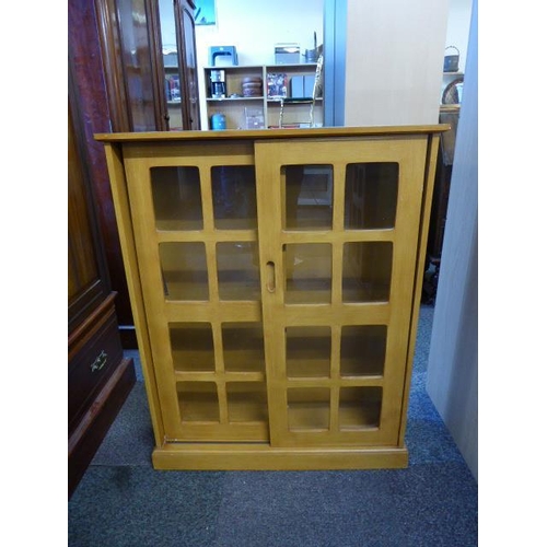 468 - Small book case with sliding glass fronted doors and cube design