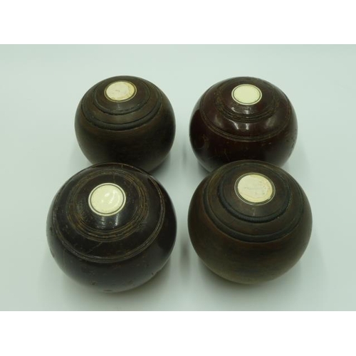 461 - Four Crown Green boules (2 bias and 2 1/2 bias) in brown leather carry bag