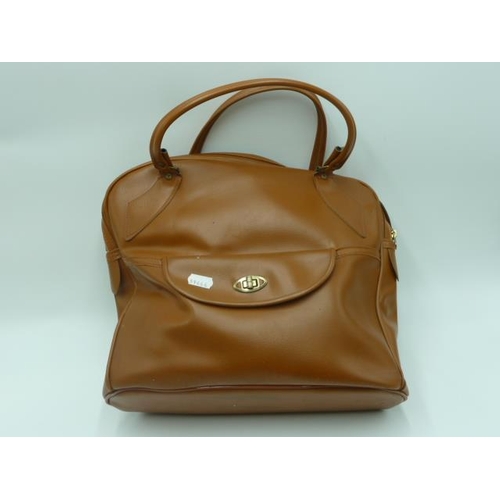 461 - Four Crown Green boules (2 bias and 2 1/2 bias) in brown leather carry bag