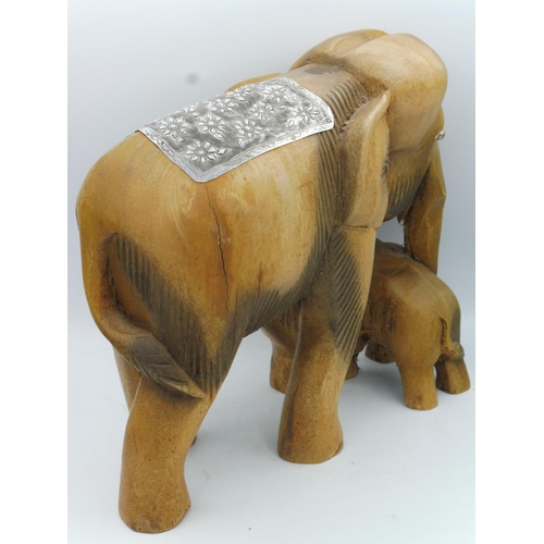 75 - A Large Hard Wood Indian Elephant with Calf Decorated with Intricately designed White Metal Head Pla... 