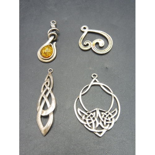 416 - Four Art Nouveau and Amber Pendants