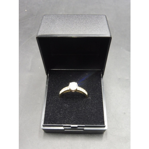 406 - Hallmarked Gold 375 Ring with Raised Solitare set in Diamante Band (Size O) Complete with Presentati... 