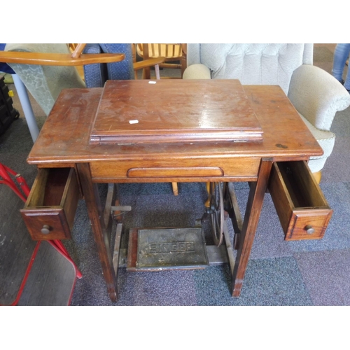 87 - A Jones Treadle Sewing Machine set in Wooden frame