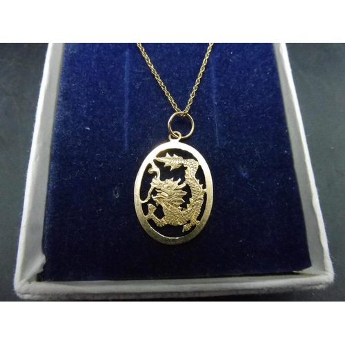 497 - 14k Gold dragon pendant on 9ct Gold chain with presentation Box