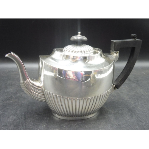 499 - Edwardian silver three piece tea set, of oval form with part fluted decoration, the teapot with an e... 