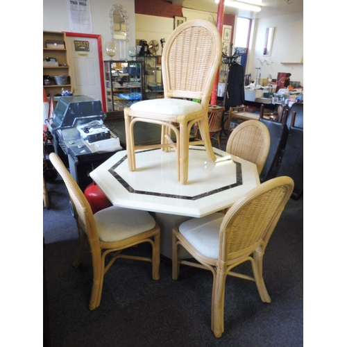 634 - A Nice Octagonal Marble style Dining Table With 4 Upholstered Bamboo Chairs.