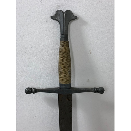 75 - Medieval Style Sword. Wire Bound grip. Demons Heads on The End Of Each Quillon. Overall Length 102cm... 