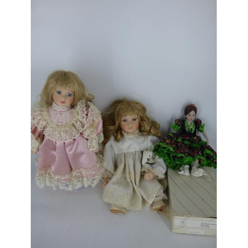 672 - Three Porcelain Dolls (One in Box and one on Stand)