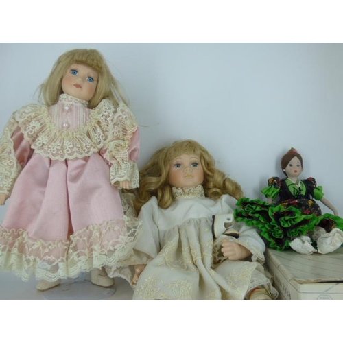 672 - Three Porcelain Dolls (One in Box and one on Stand)