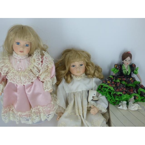 672 - Three Porcelain Dolls (One in Box and one on Stand)