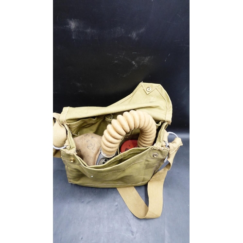 156 - WWII British Army Fabric Fronted Rubber gas mask dated 1940, plus a canvas case dating 1943