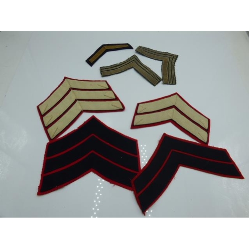 73 - Four British guards regiment uniform chevrons plus a pair and a single braid chevron stripes