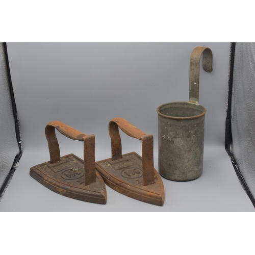 217 - 2 x Vintage Cast Iron Flat Irons with a Metal Pint Measuring Ladel.